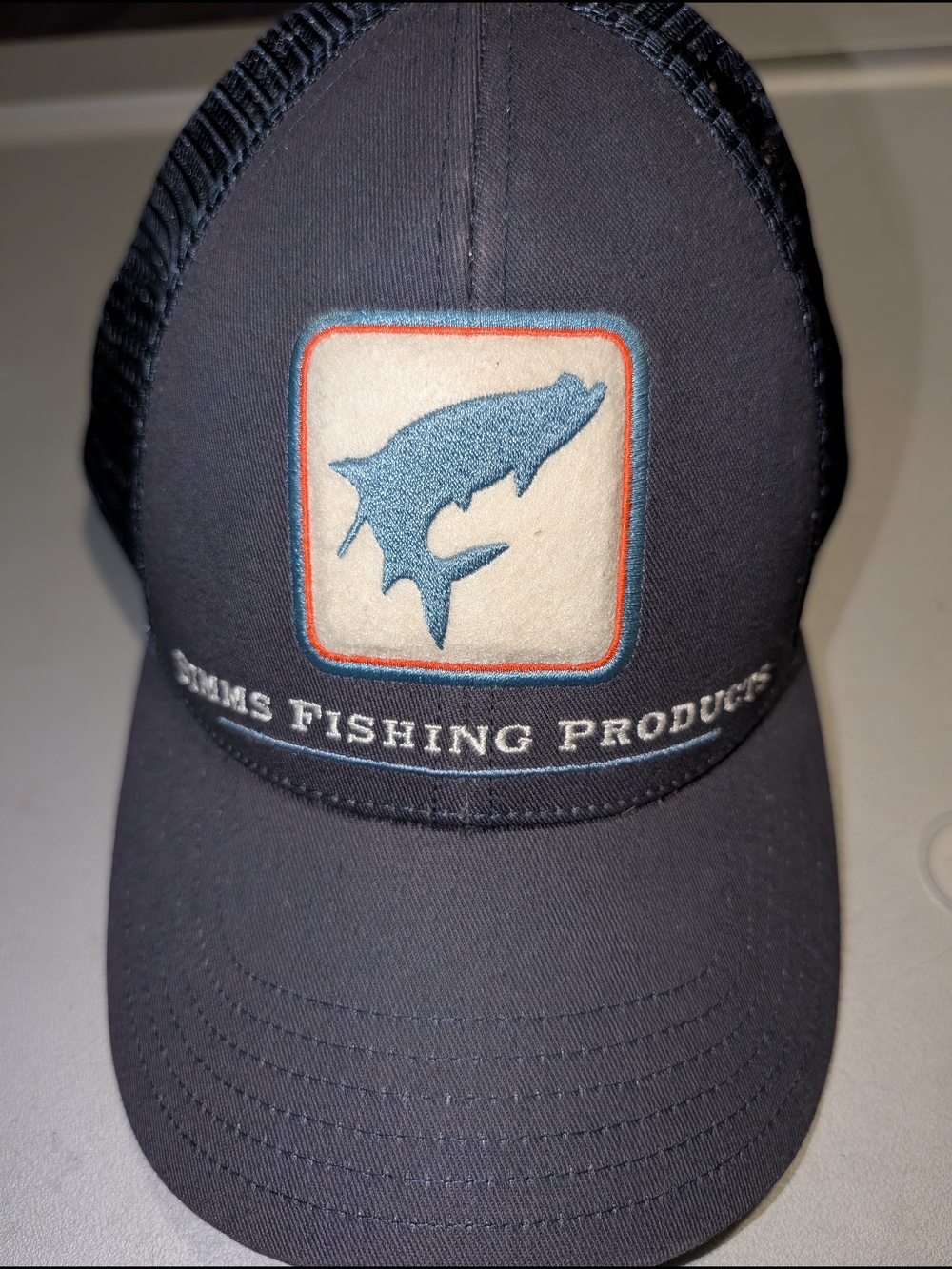 Simms Navy Fishing Cap with Blue Fish Patch and Orange Trim